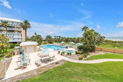 a spacious bedroom with a bed and a large window