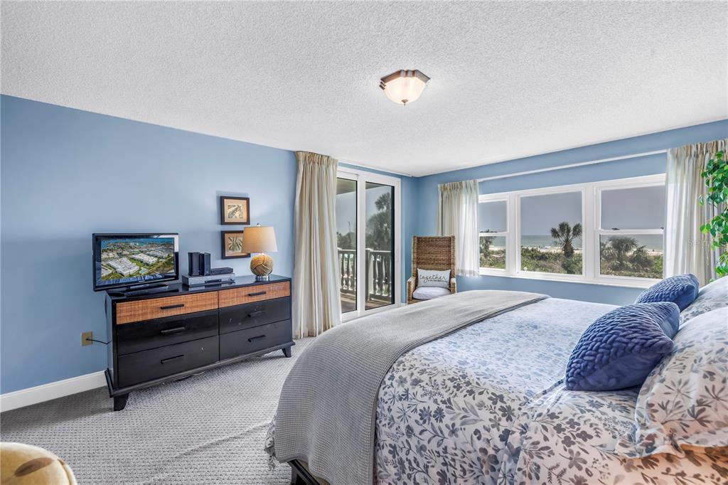 6600 Sunset Way, Unit 118 St. Pete Beach, FL 33706 - Photo 23 of 64 a bedroom with a bed and a large window