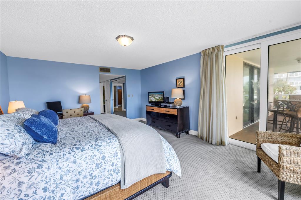 6600 Sunset Way, Unit 118 St. Pete Beach, FL 33706 - Photo 25 of 64 a spacious bedroom with a bed and a large window