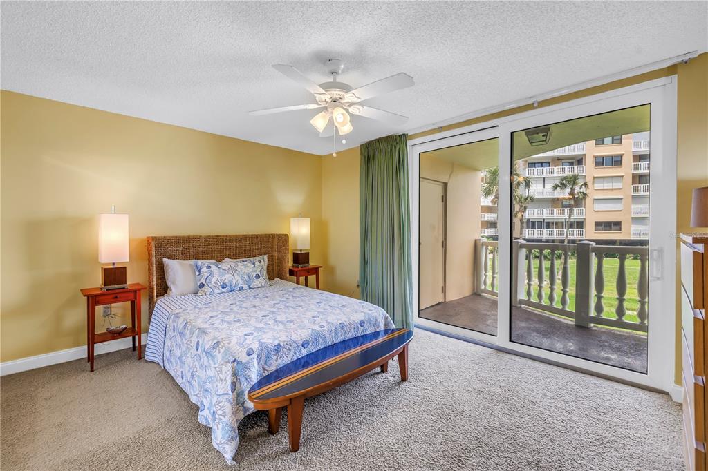 6600 Sunset Way, Unit 118 St. Pete Beach, FL 33706 - Photo 31 of 64 a bedroom with a bed and a chandelier
