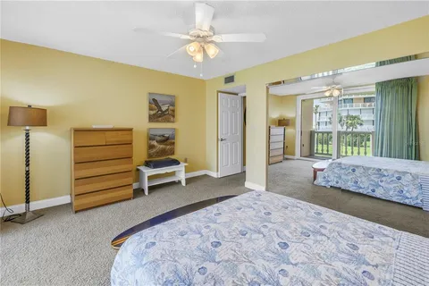 a living room with furniture a flat screen tv and a large window