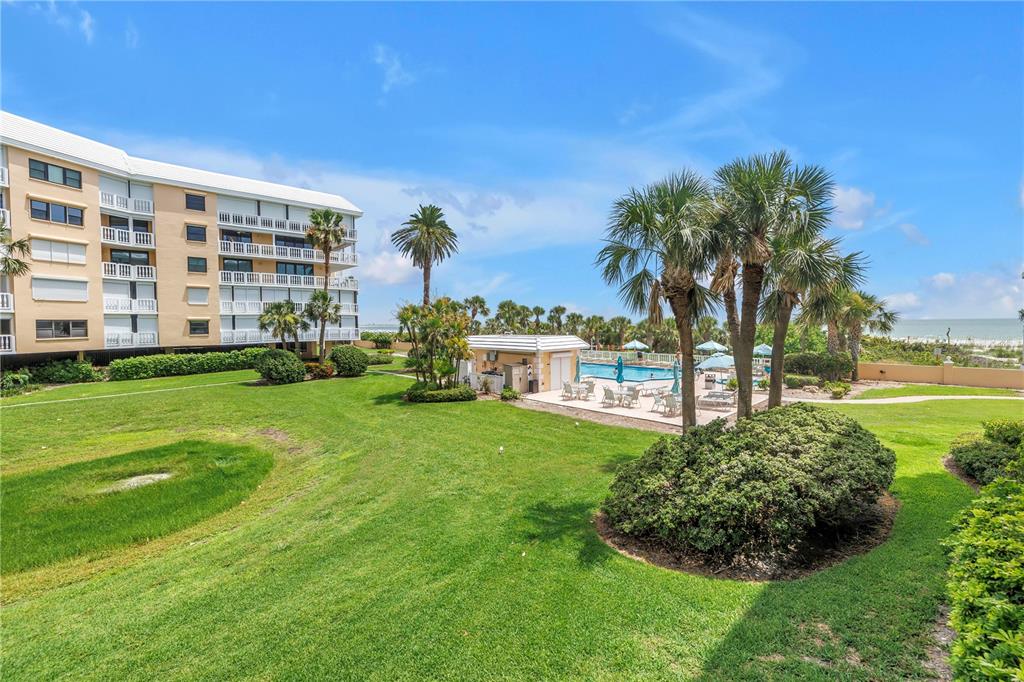 6600 Sunset Way, Unit 118 St. Pete Beach, FL 33706 - Photo 34 of 64 a view of a house with a backyard