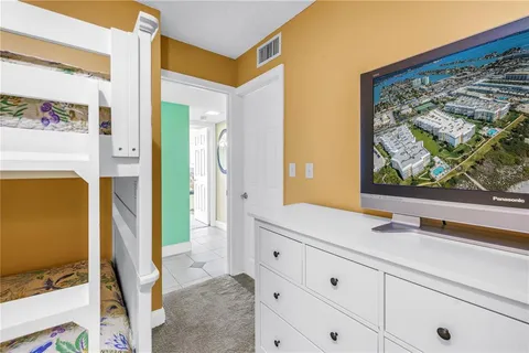a front view of a house with a yard and potted plants