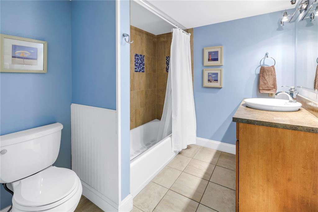 6600 Sunset Way, Unit 118 St. Pete Beach, FL 33706 - Photo 38 of 64 a bathroom with a sink a toilet and shower