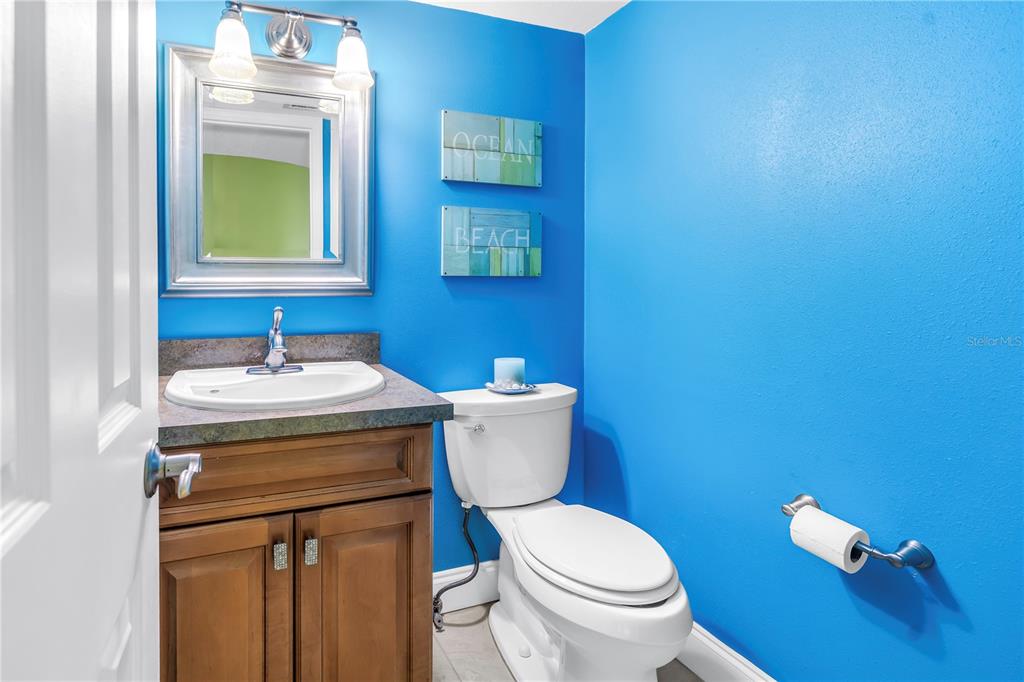 6600 Sunset Way, Unit 118 St. Pete Beach, FL 33706 - Photo 39 of 64 a bathroom with a toilet a sink and mirror
