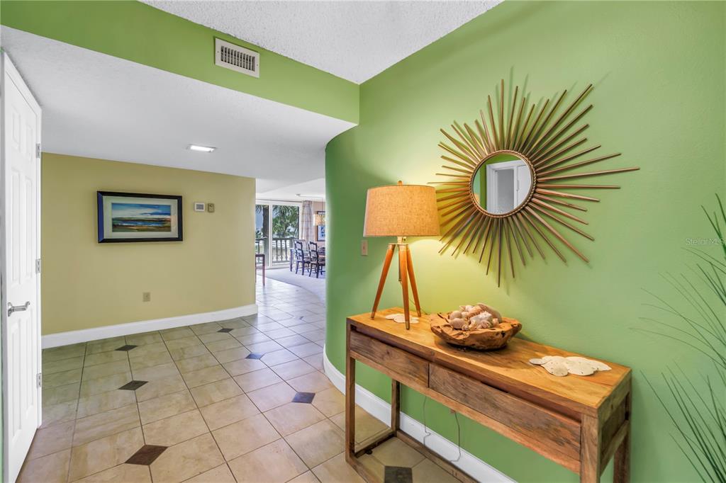 6600 Sunset Way, Unit 118 St. Pete Beach, FL 33706 - Photo 4 of 64 a view of a room with a table and chairs