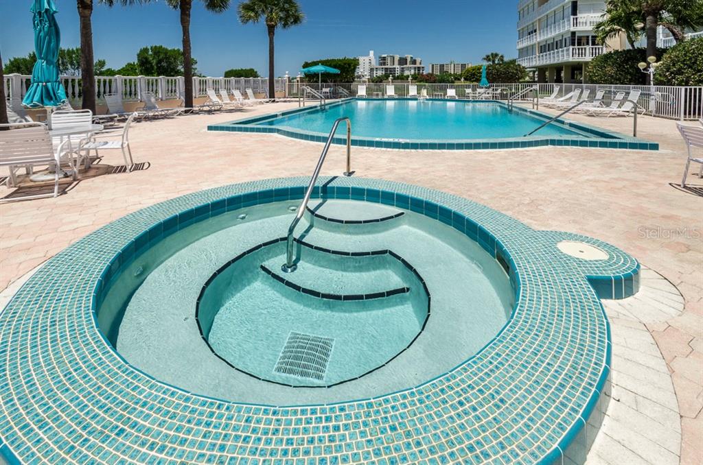 6600 Sunset Way, Unit 118 St. Pete Beach, FL 33706 - Photo 44 of 64 a view of a swimming pool with outdoor seating