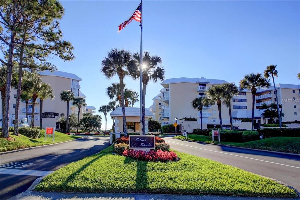 6600 Sunset Way, Unit 118 St. Pete Beach, FL 33706 - Photo 47 of 64 a front view of a house with a yard and potted plants