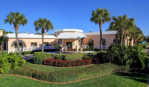 a view of a pathway of a house next to a yard
