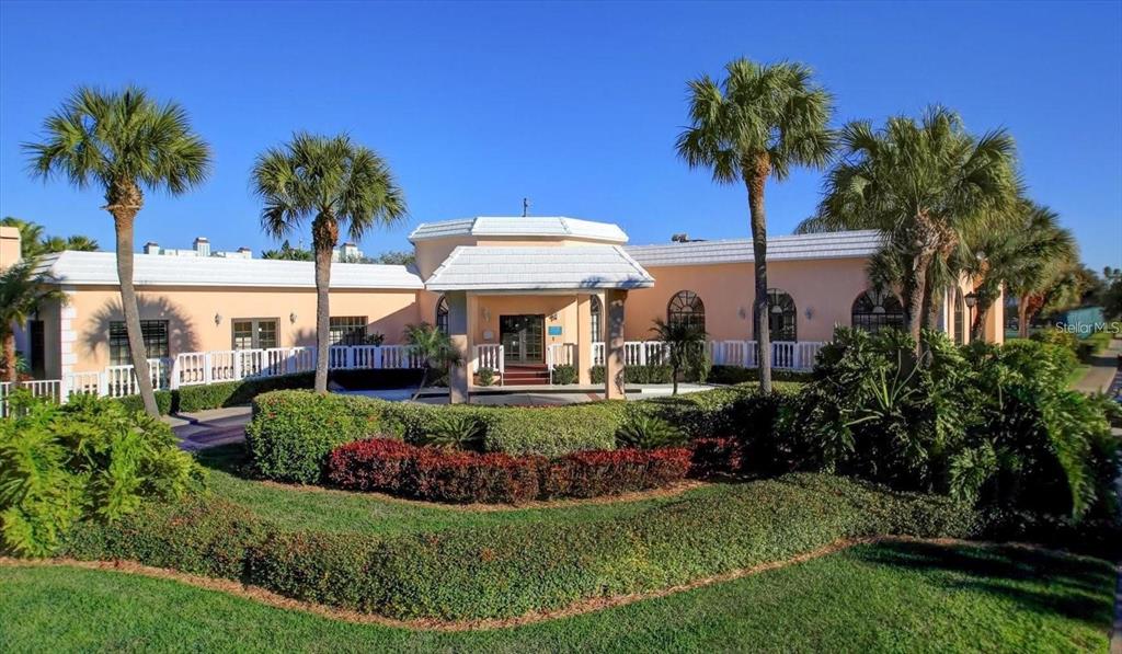 6600 Sunset Way, Unit 118 St. Pete Beach, FL 33706 - Photo 48 of 64 a view of a house with a garden and swimming pool