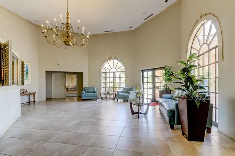 a multi story building with swimming pool and lawn chairs