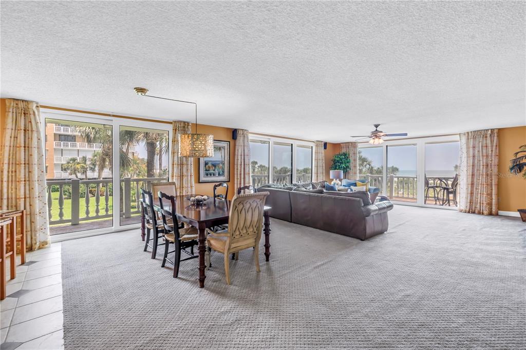 6600 Sunset Way, Unit 118 St. Pete Beach, FL 33706 - Photo 5 of 64 a living room with furniture and a floor to ceiling window