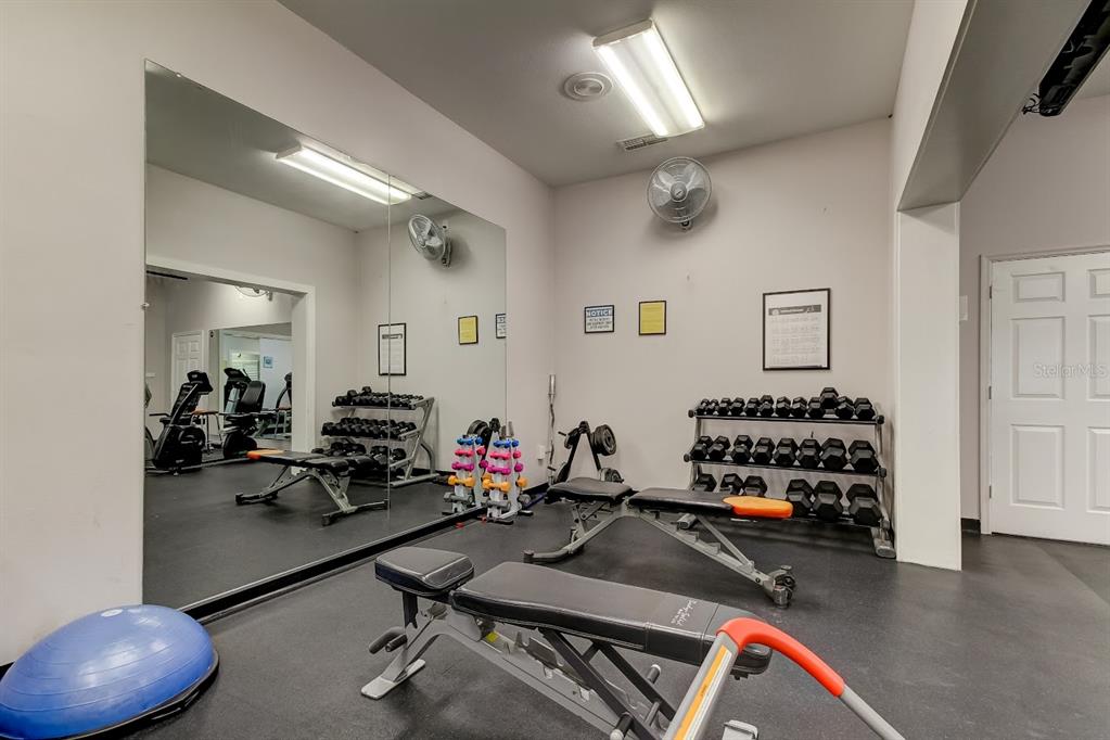 6600 Sunset Way, Unit 118 St. Pete Beach, FL 33706 - Photo 55 of 64 a room with gym equipment and gym equipment
