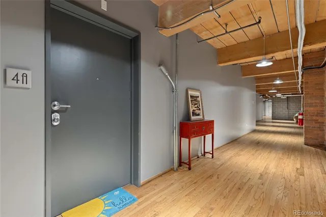 a view of a hallway with wooden floor