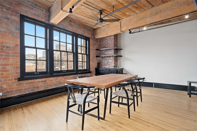 a table and chairs in a room next to a window
