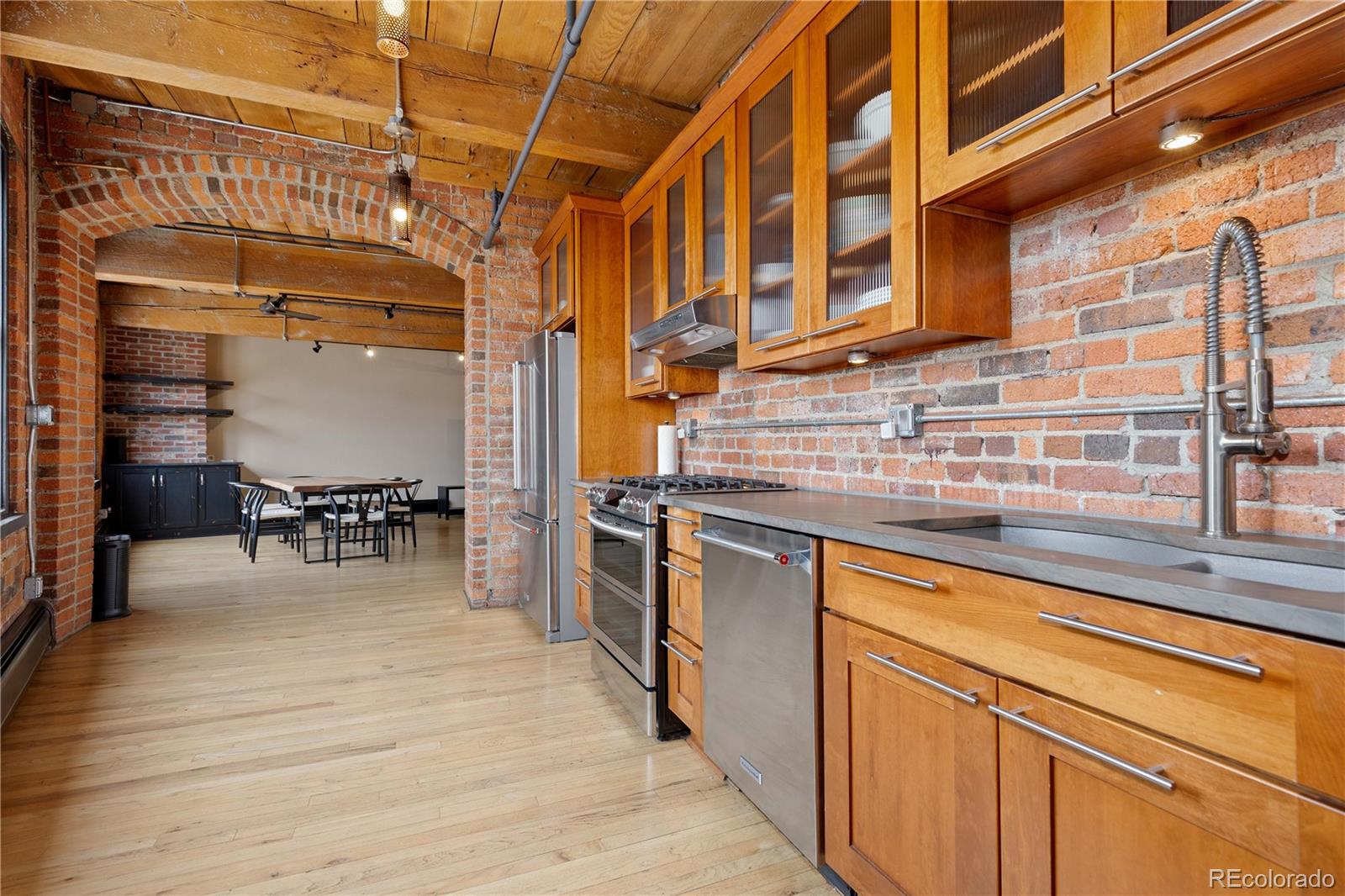 1616 14th Street, Unit 4A Denver, CO 80202 - Photo 18 of 43 a kitchen with stainless steel appliances granite countertop a stove and cabinets