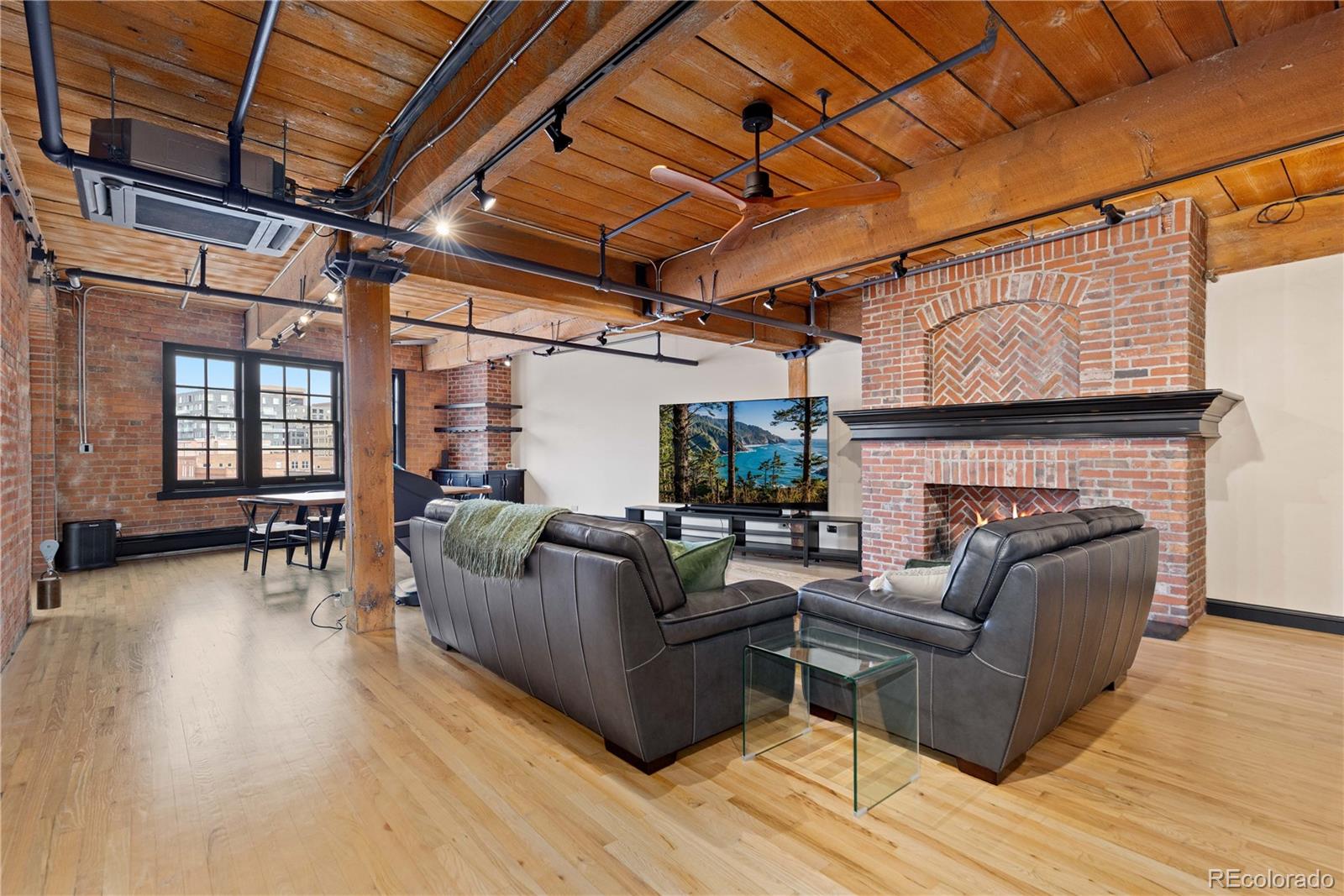 1616 14th Street, Unit 4A Denver, CO 80202 - Photo 21 of 43 a living room with furniture a fireplace wooden floor and a table