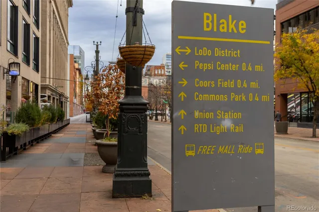 a sign board on a city street