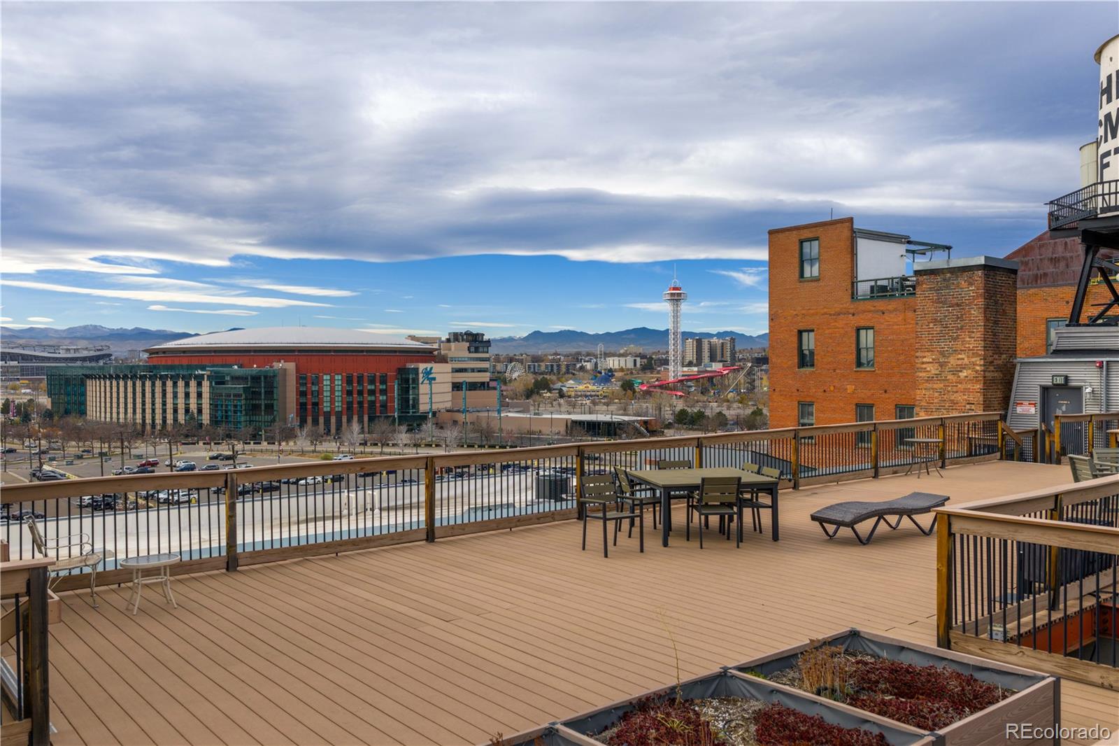 1616 14th Street, Unit 4A Denver, CO 80202 - Photo 8 of 43 a view of a roof deck with dining table and chairs with wooden floor