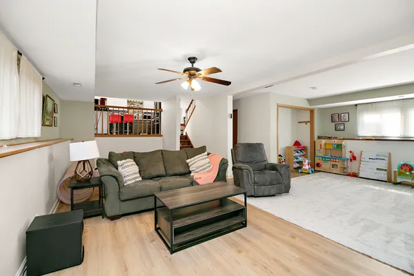 a living room with furniture and a chandelier