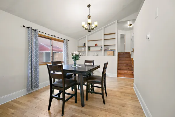 a view of a dining room with furniture and chandelier