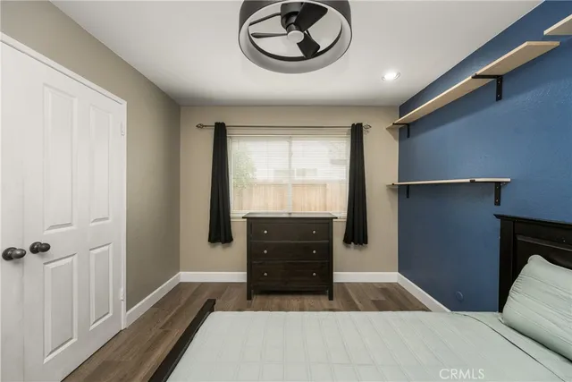 a bedroom with a bed and a dresser