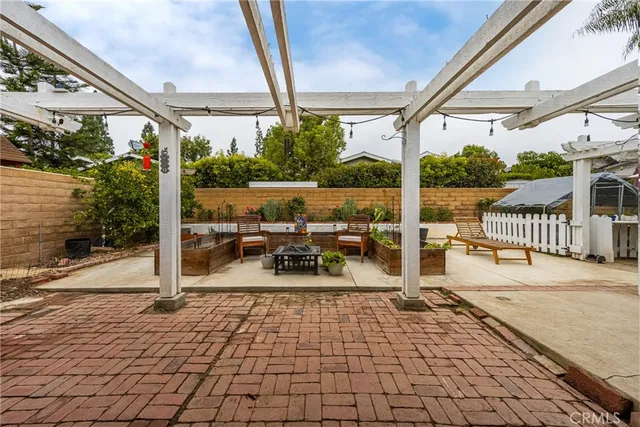 a view of a patio with a dining table and chairs with wooden floor