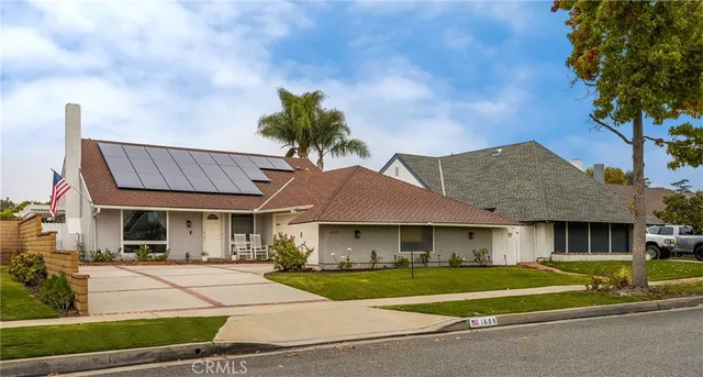 a front view of a house with a yard table and chairs