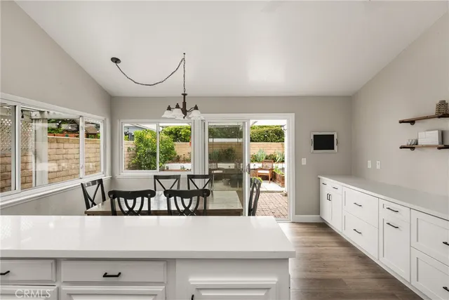 a view of a kitchen with granite countertop a large window and a sink