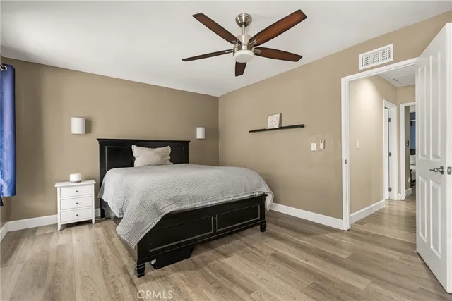 a bedroom with a bed and a ceiling fan