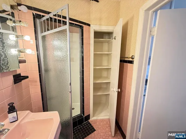 a bathroom with a sink and shower