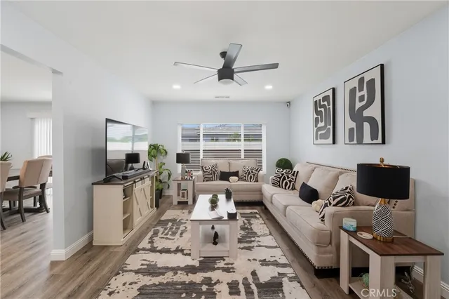 a living room with furniture a rug and a flat screen tv
