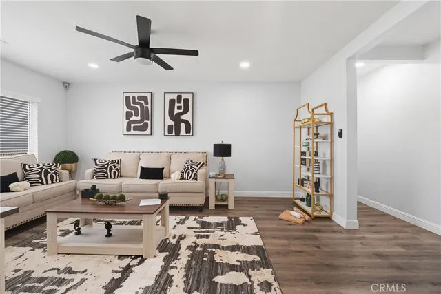 a living room with furniture and wooden floor