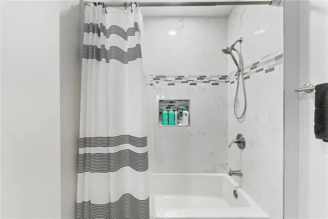 a bathroom with a bathtub and a shower