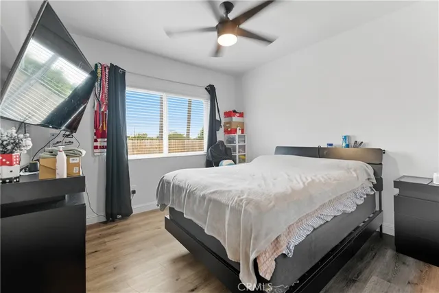 a bed sitting in a bedroom next to a window