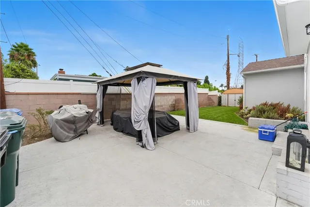 a view of a patio with table and chairs a barbeque
