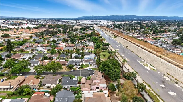 an aerial view of a house with a garden and trees