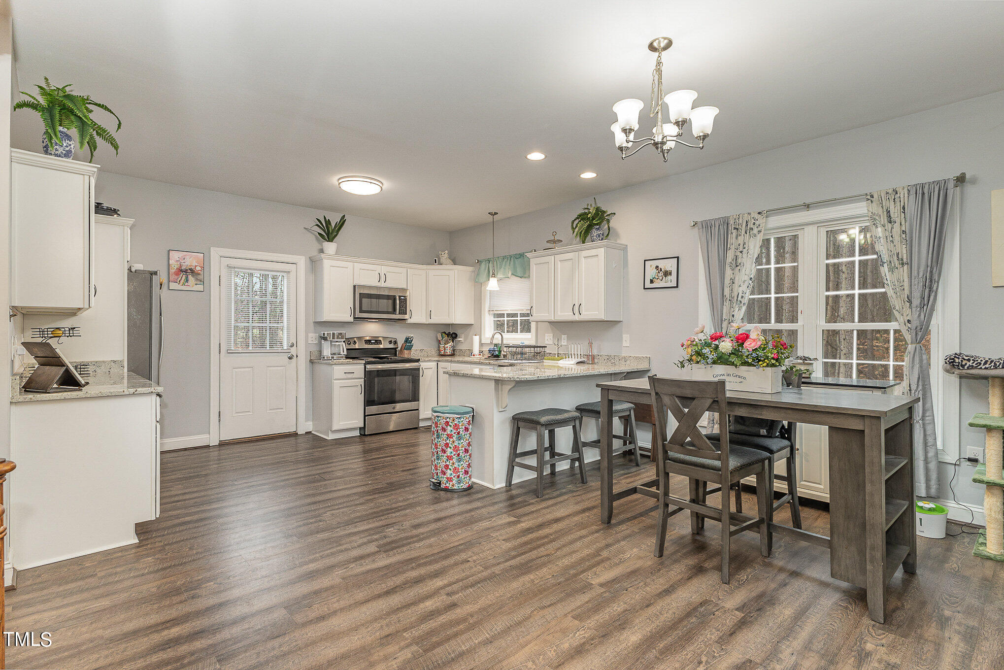107 Piney Forest Road Roxboro, NC 27574 - Photo 15 of 27 a open dining room with kitchen island furniture a chandelier and kitchen view