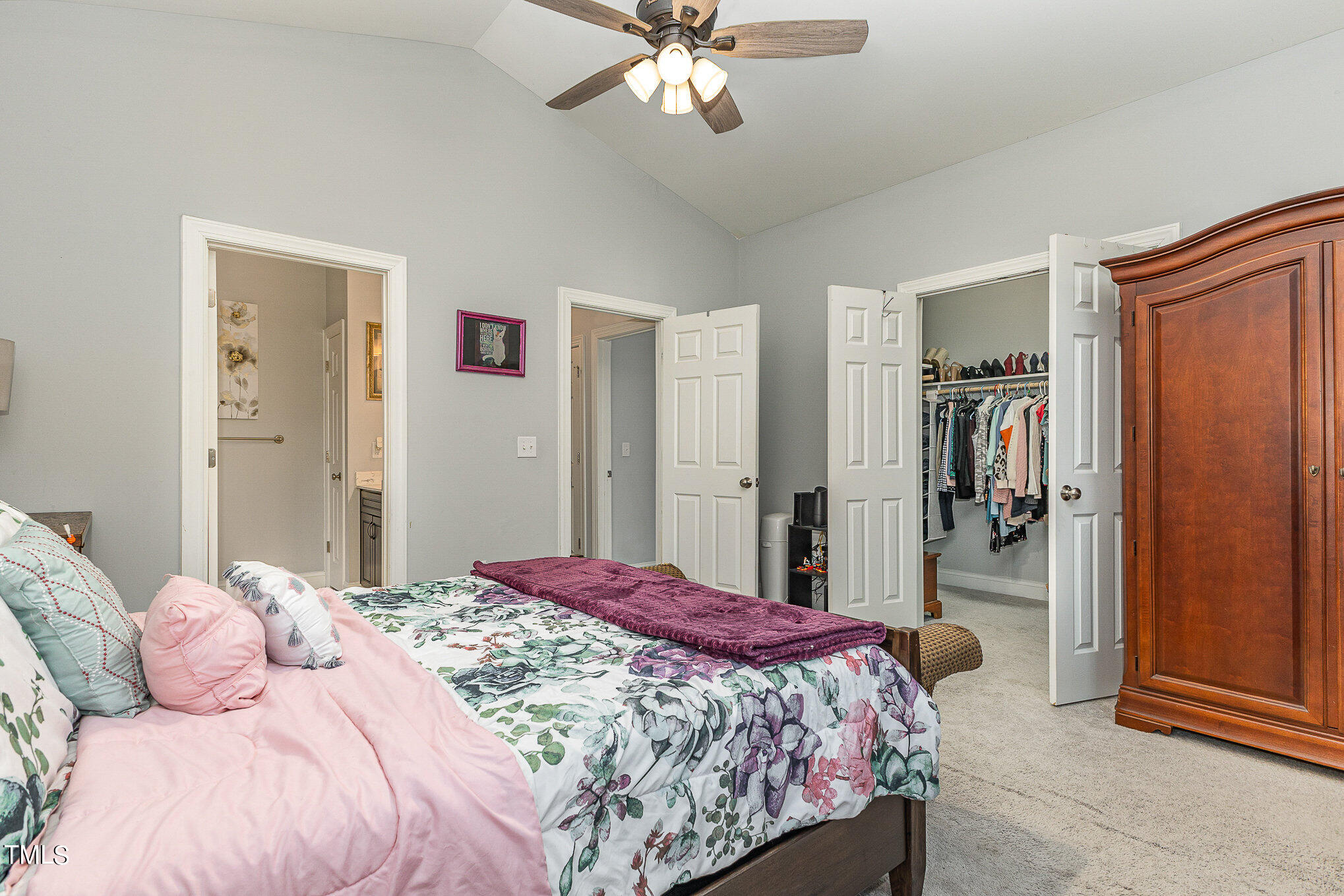 107 Piney Forest Road Roxboro, NC 27574 - Photo 18 of 27 a bedroom with a bed and a chandelier
