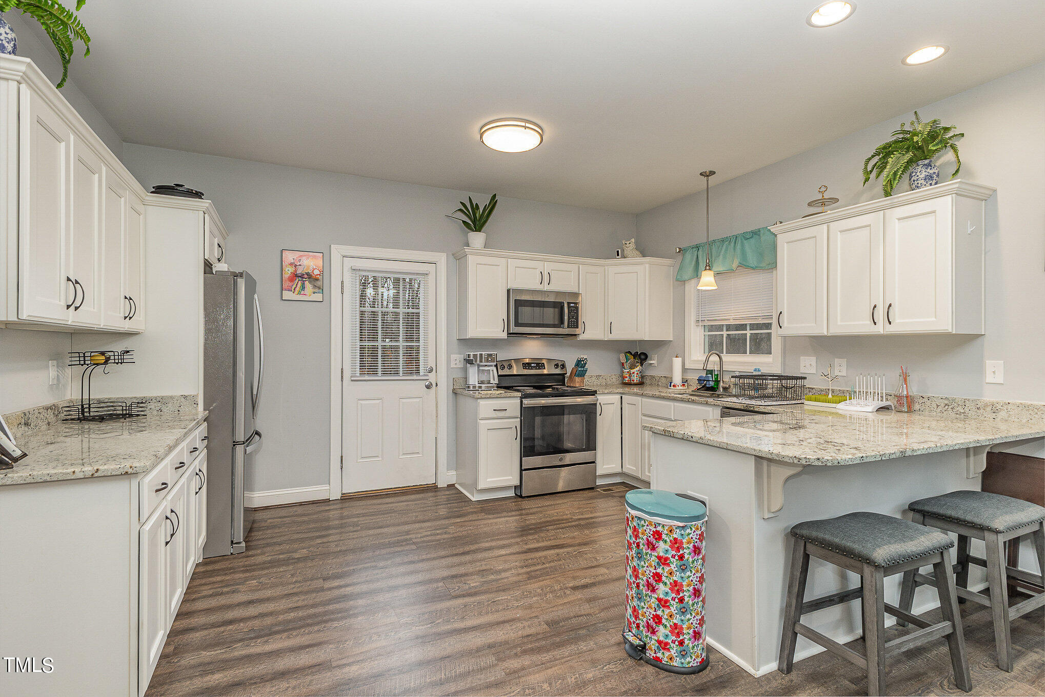 107 Piney Forest Road Roxboro, NC 27574 - Photo 9 of 27 a kitchen with granite countertop a sink cabinets stainless steel appliances and a center island