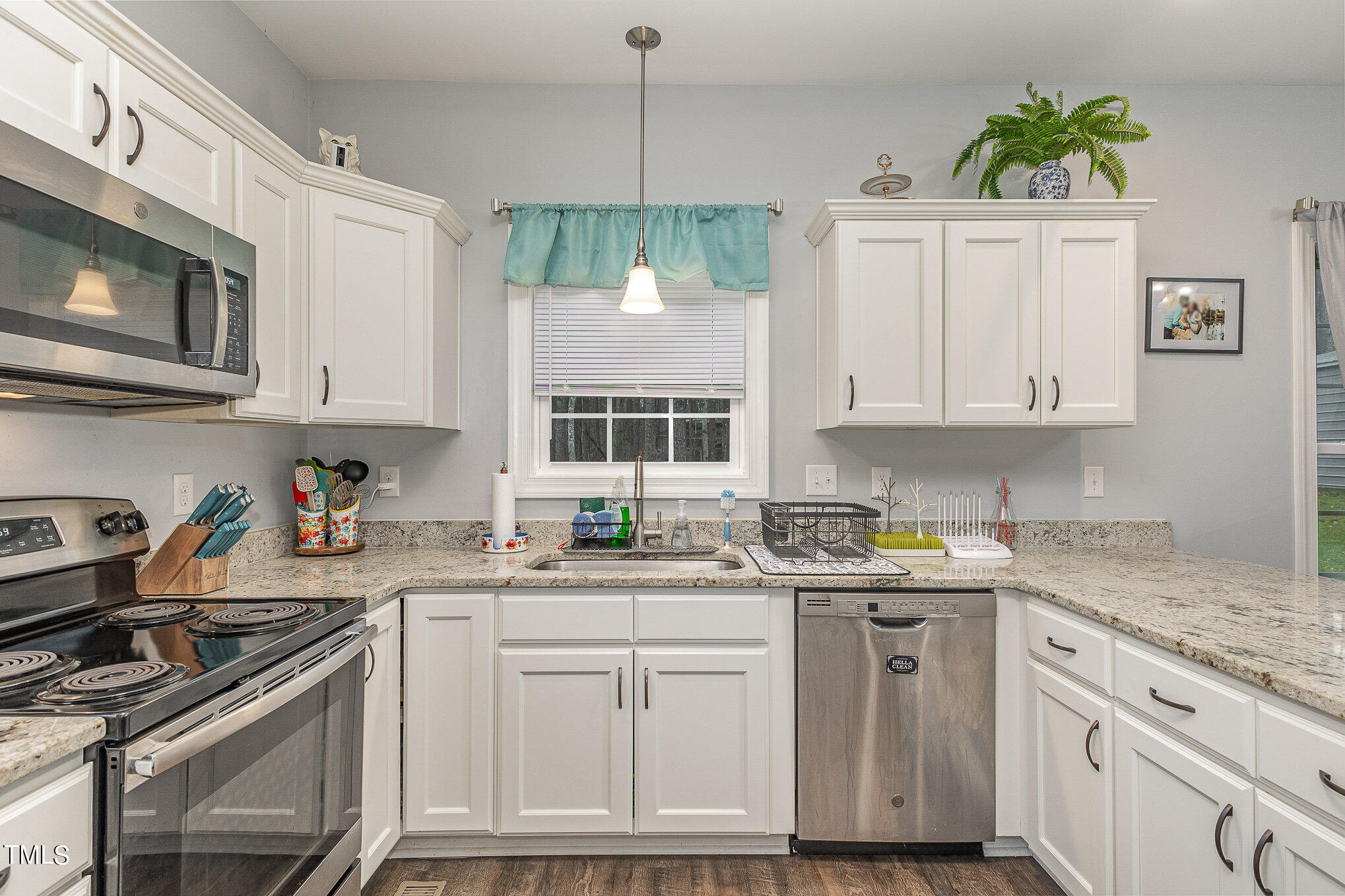107 Piney Forest Road Roxboro, NC 27574 - Photo 10 of 27 a kitchen with stainless steel appliances granite countertop a sink stove and cabinets