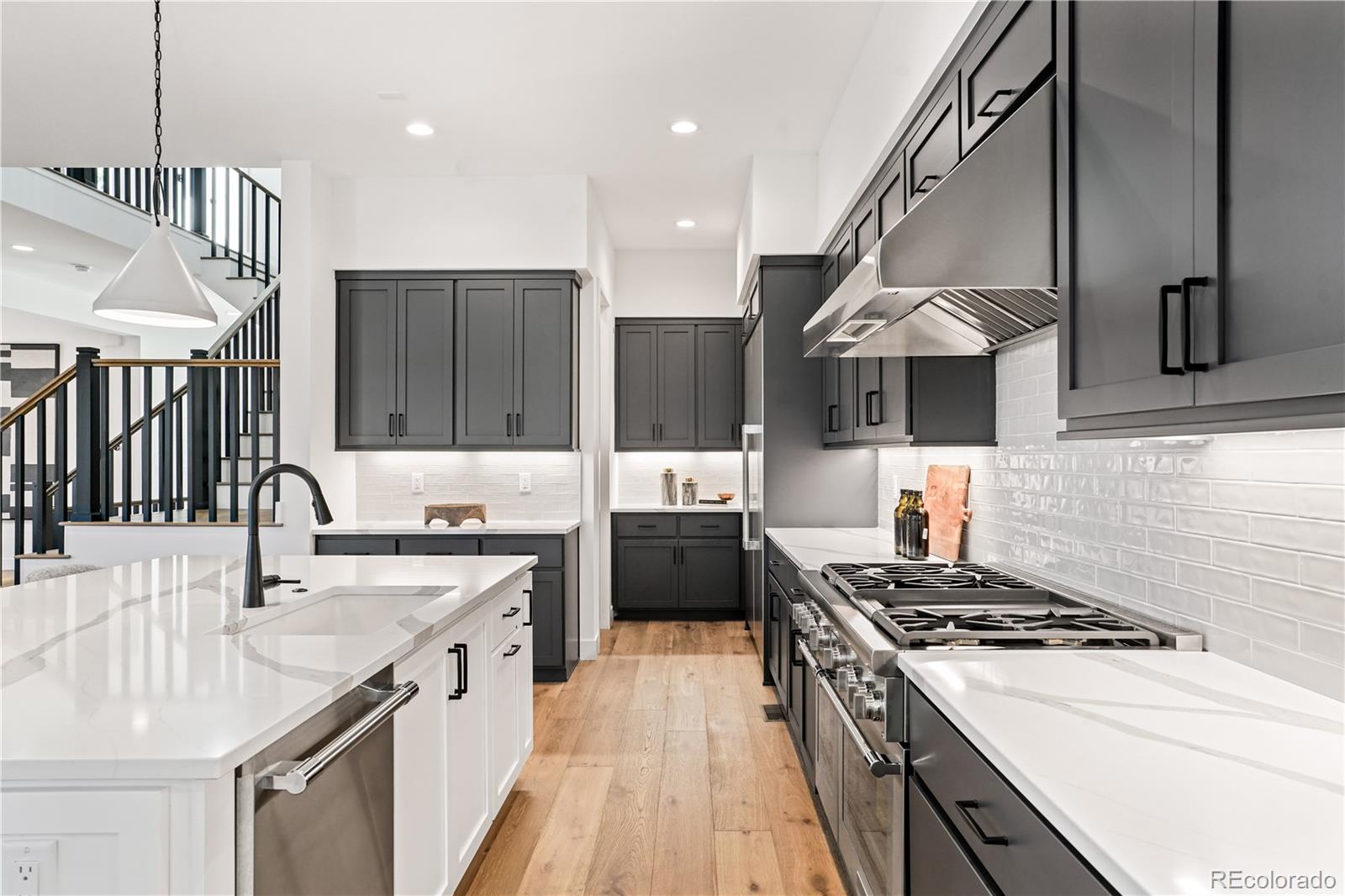 1067 South Cook Street Denver, CO 80209 - Photo 12 of 35 a kitchen with a stove sink and cabinets