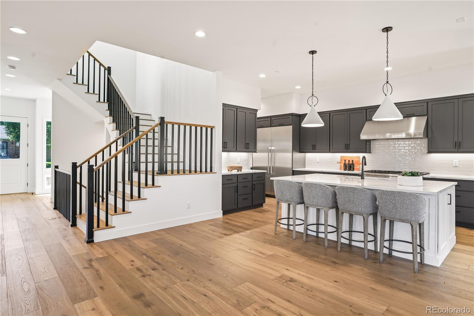 1067 South Cook Street Denver, CO 80209 - Photo 13 of 35 a open kitchen with stainless steel appliances wooden floor and a view of living room