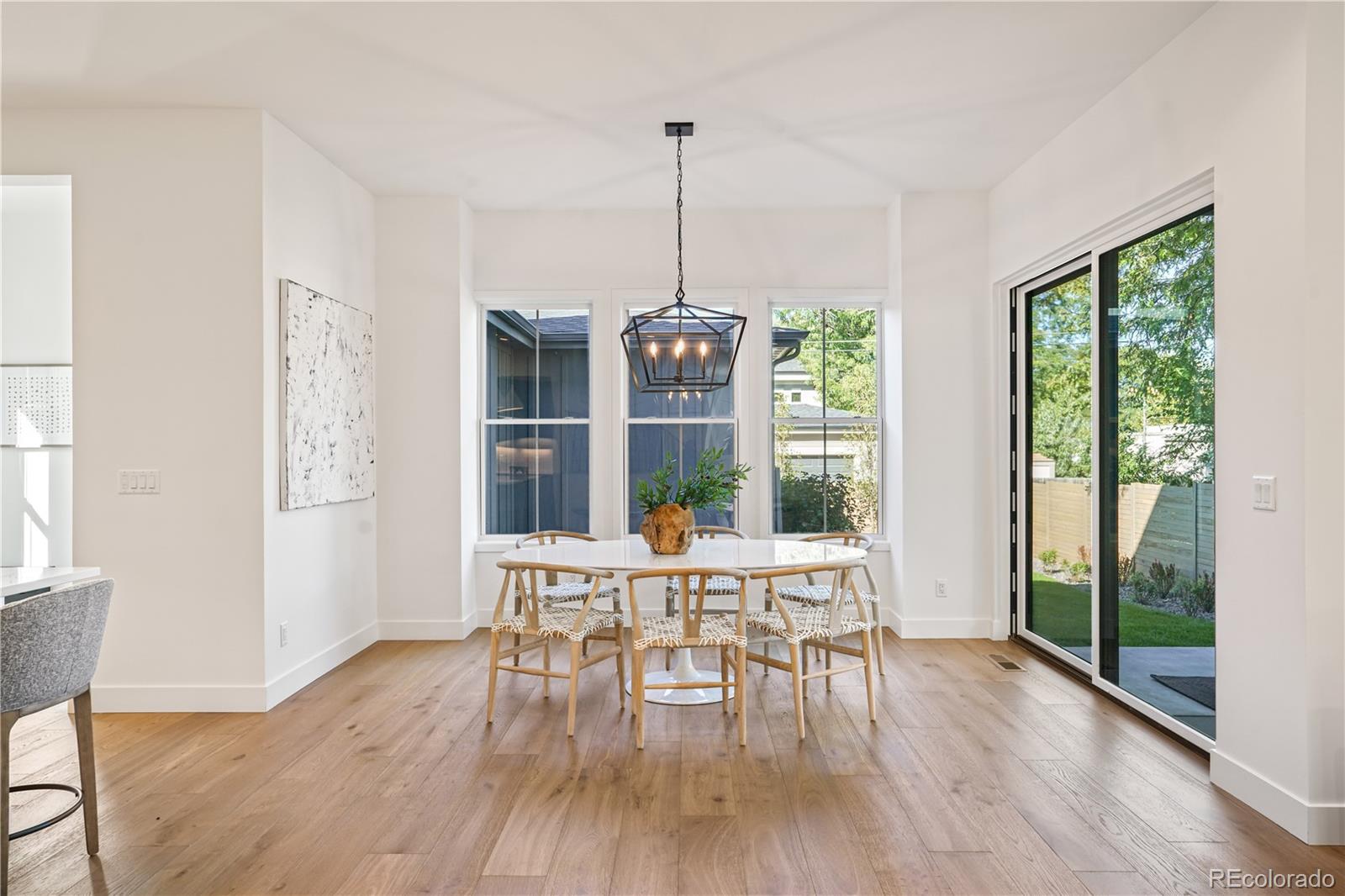 1067 South Cook Street Denver, CO 80209 - Photo 15 of 35 a dining room with furniture window wooden floor