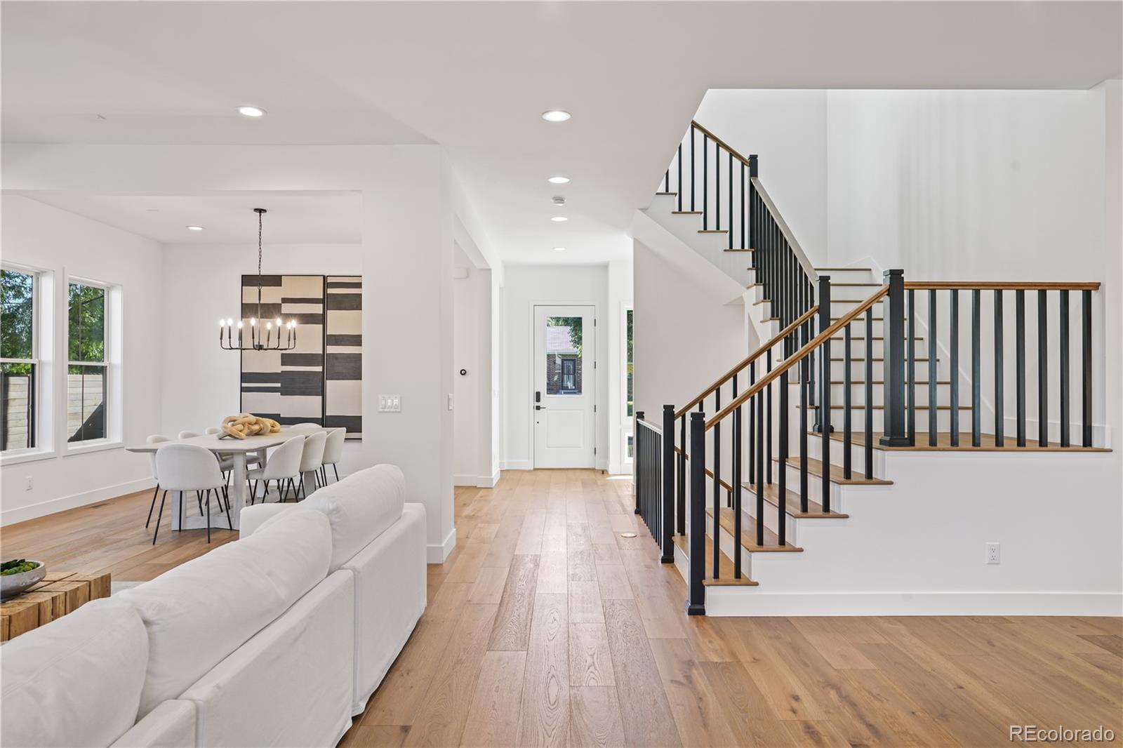 1067 South Cook Street Denver, CO 80209 - Photo 17 of 35 a view of a hallway with wooden floor and staircase