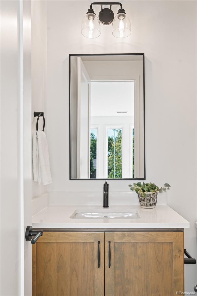 1067 South Cook Street Denver, CO 80209 - Photo 19 of 35 a bathroom with a sink and a mirror