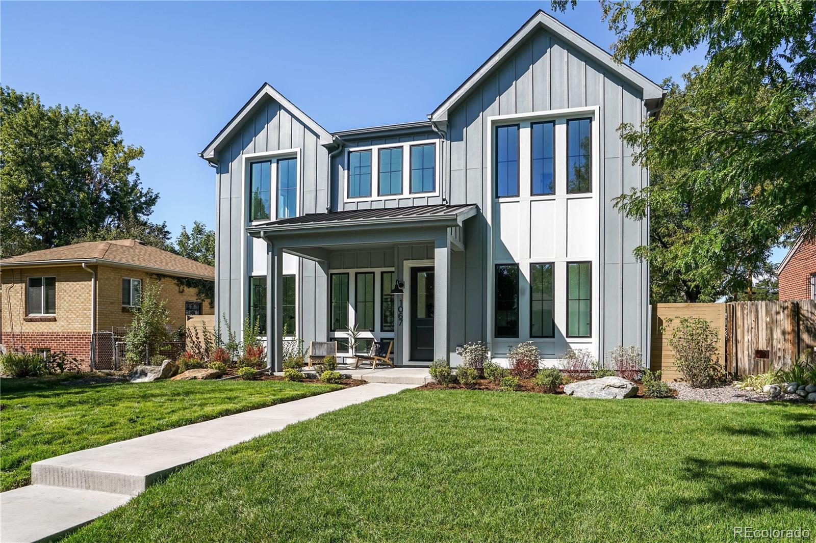 1067 South Cook Street Denver, CO 80209 - Photo 2 of 35 a front view of a house with a yard table and chairs