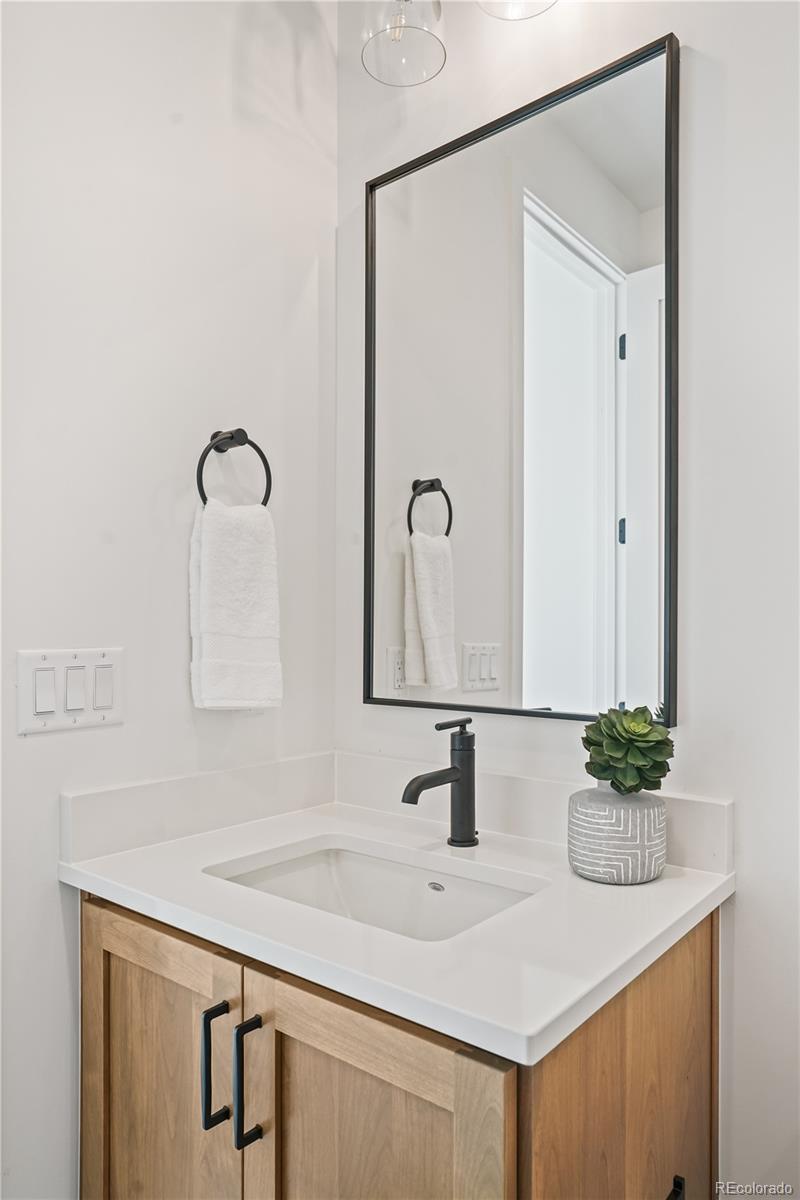 1067 South Cook Street Denver, CO 80209 - Photo 22 of 35 a bathroom with a sink and a mirror