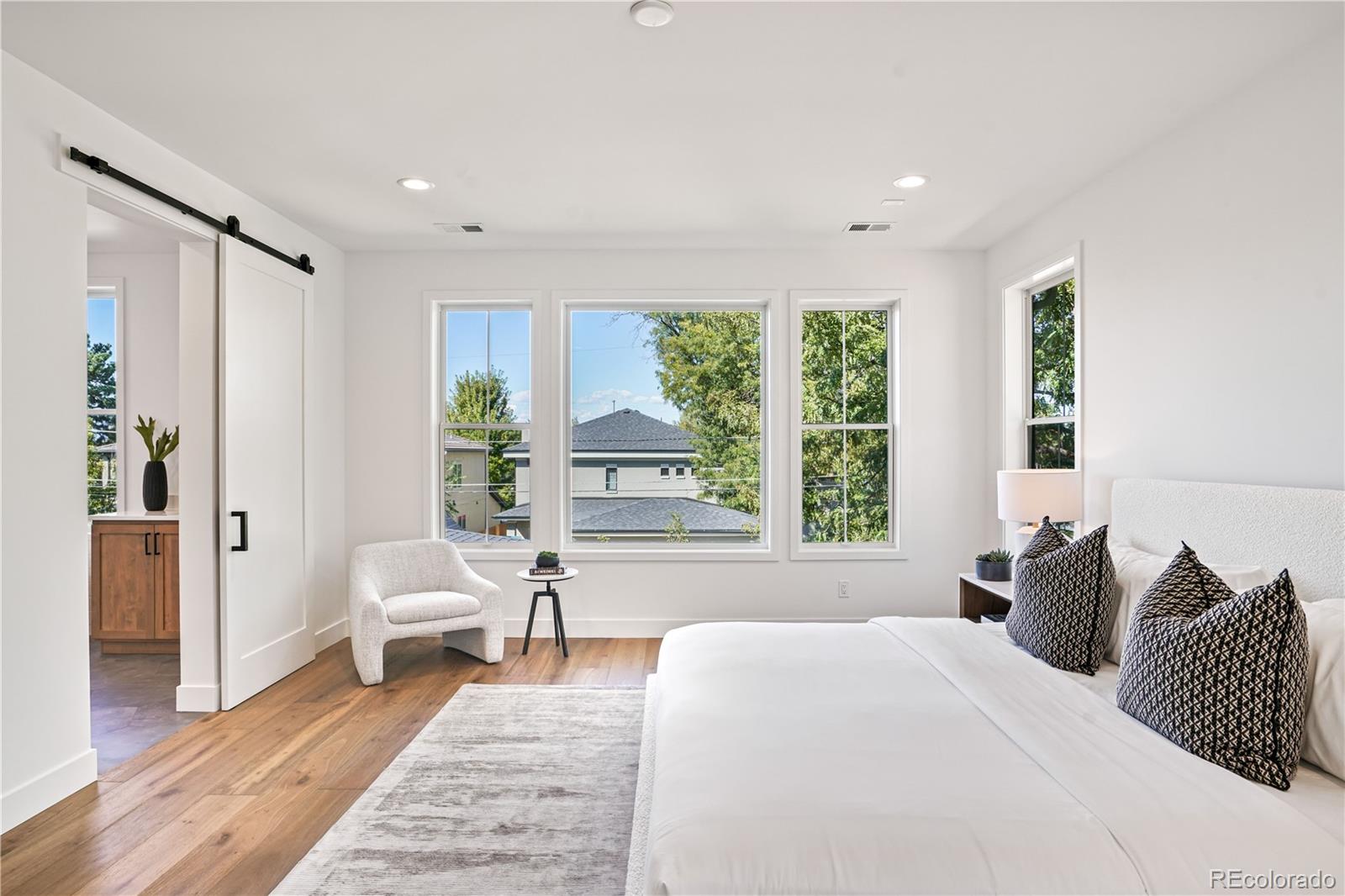 1067 South Cook Street Denver, CO 80209 - Photo 25 of 35 a spacious bedroom with a bed and a large window