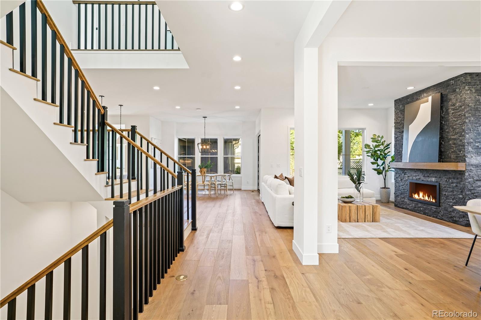 1067 South Cook Street Denver, CO 80209 - Photo 3 of 35 a view of a hallway with wooden floor and a fireplace